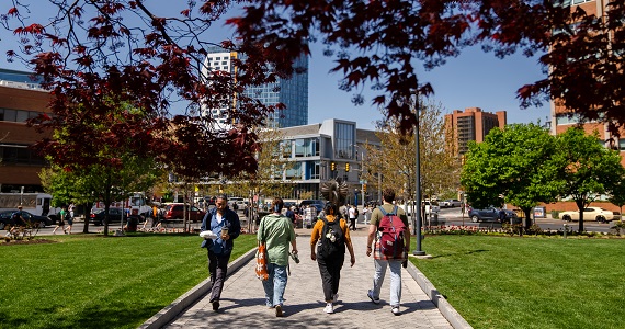 Students walk toward a busy intersection on Drexel campus